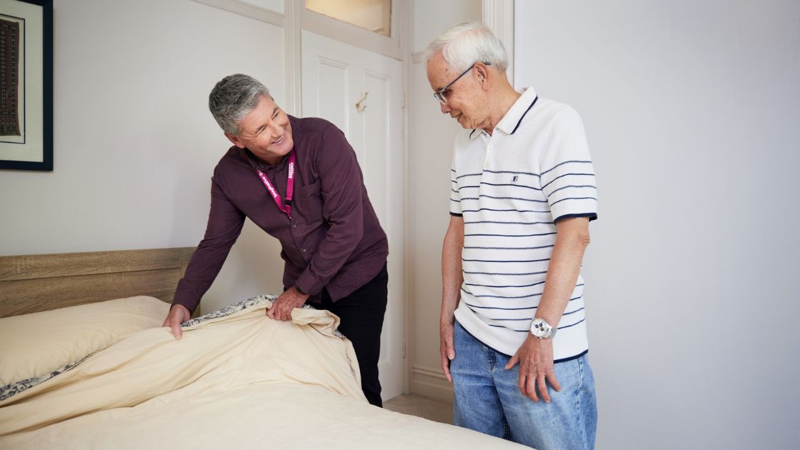  Uniting care worker supporting senior man at home