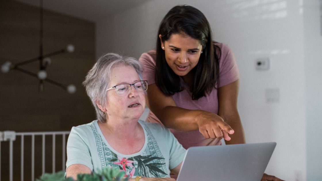 Senior woman and advisor reviewing Uniting home care costs and package options together
