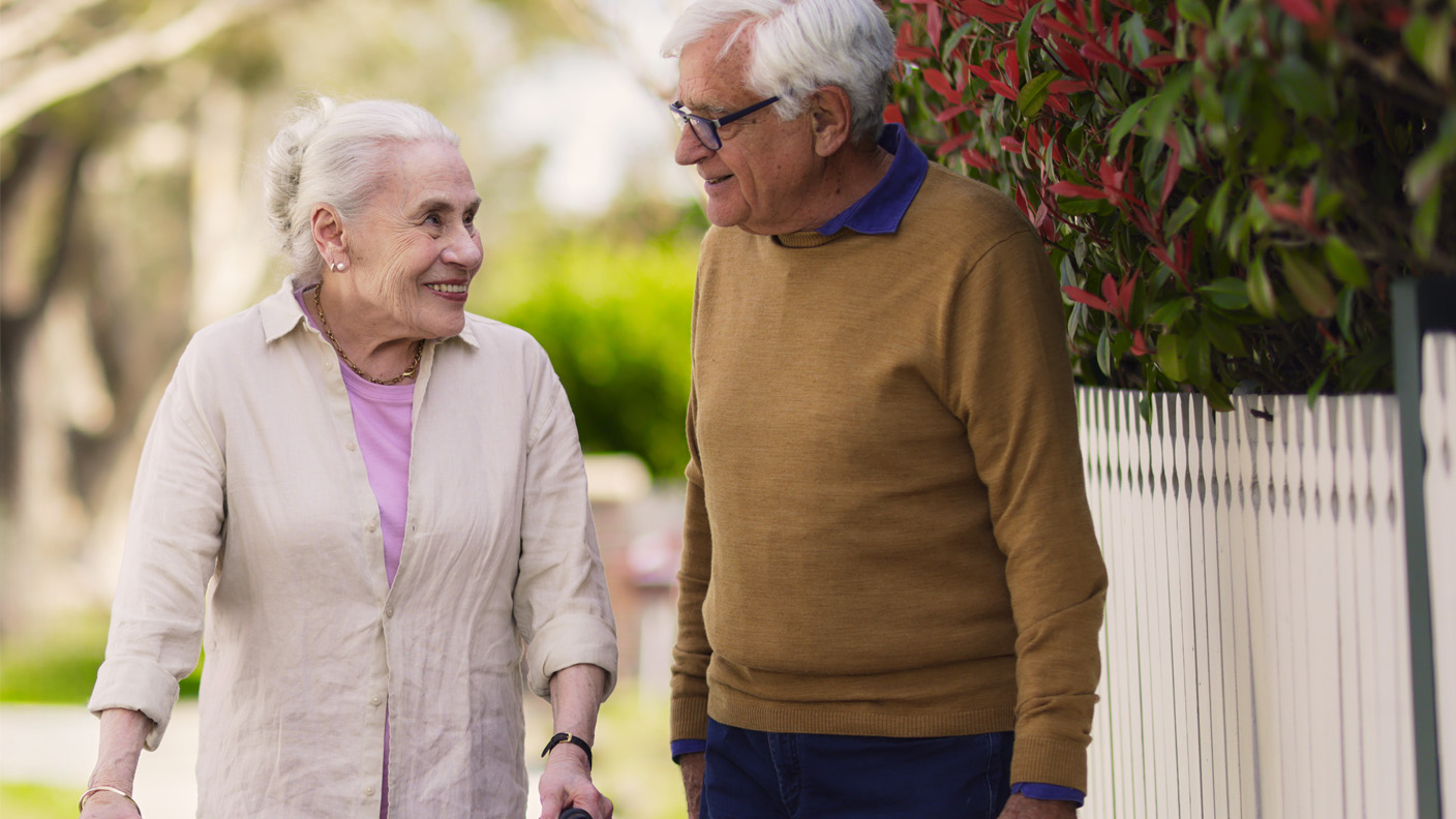 Senior couple enjoying a neighbourhood walk Senior couple enjoying a neighbourhood walk