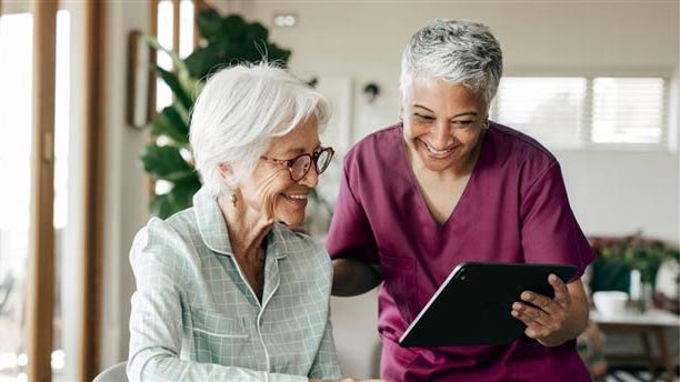 Uniting care worker assisting a senior woman to estimate her home care costs online