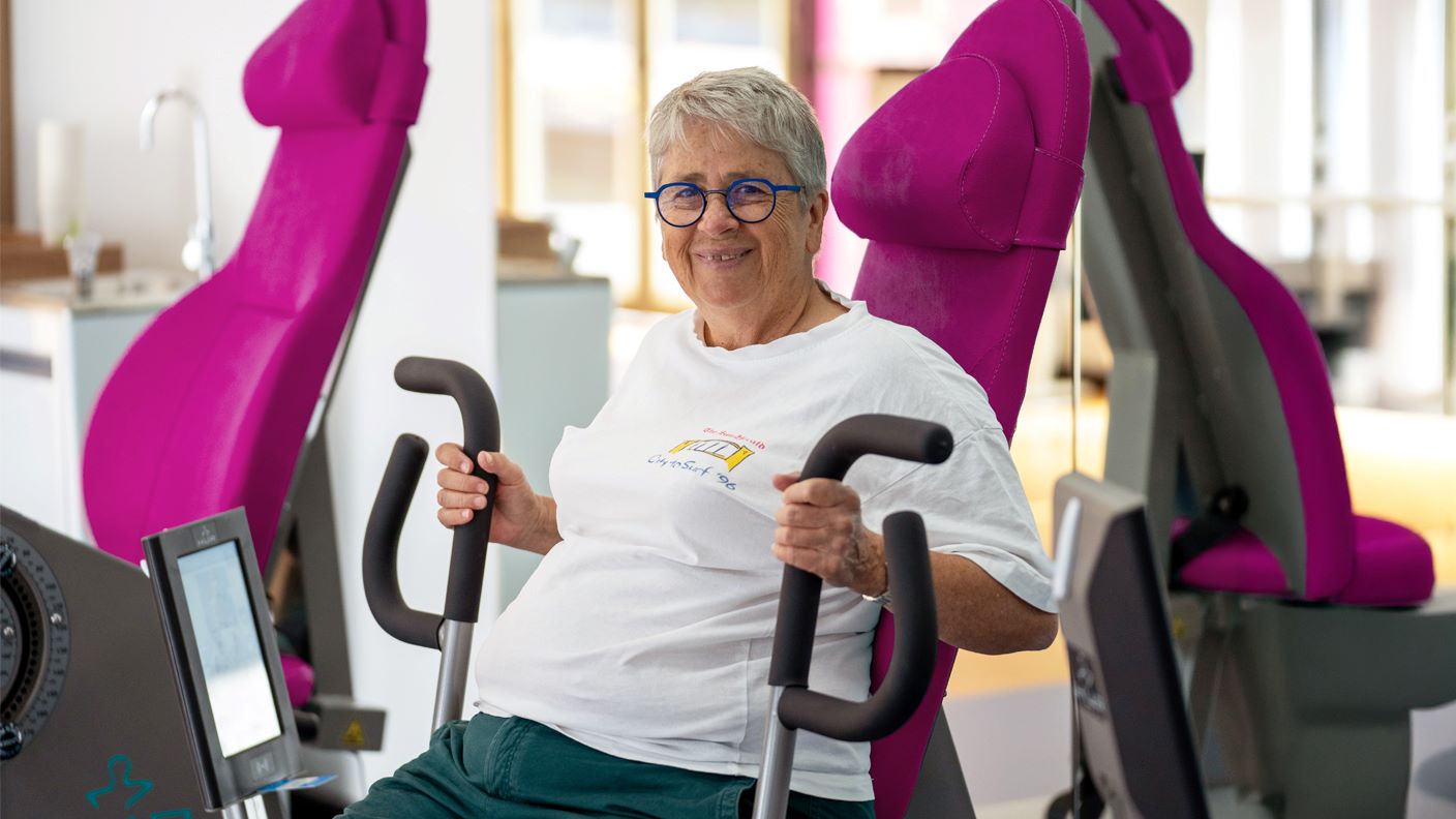 Senior lady using a gym machine
