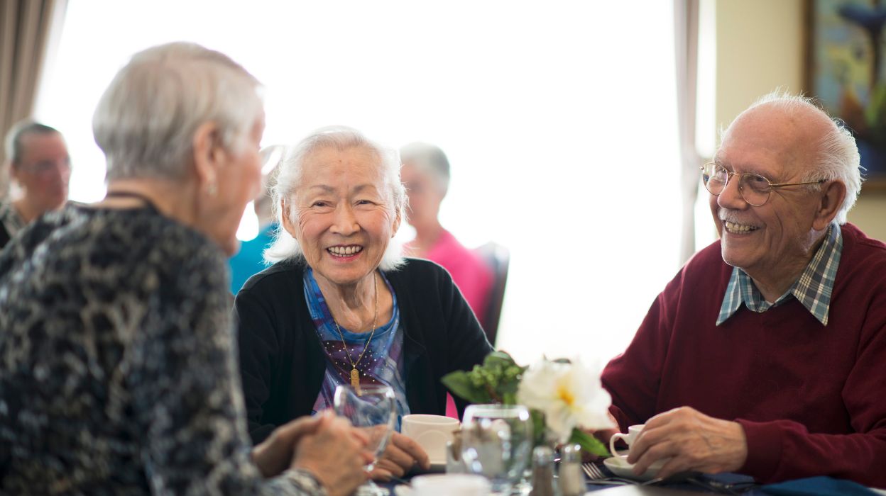 Older man and women catching up in a cafe