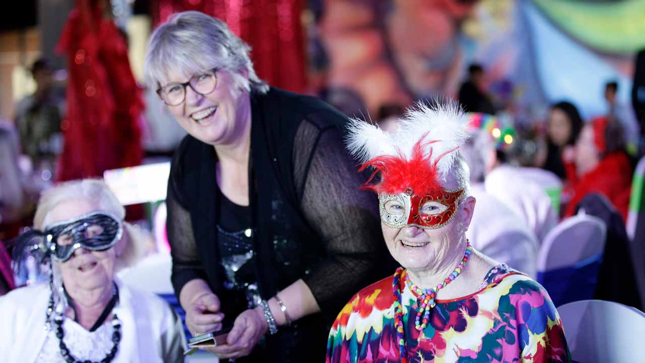 Seniors wearing masks and finery for the seniors ball