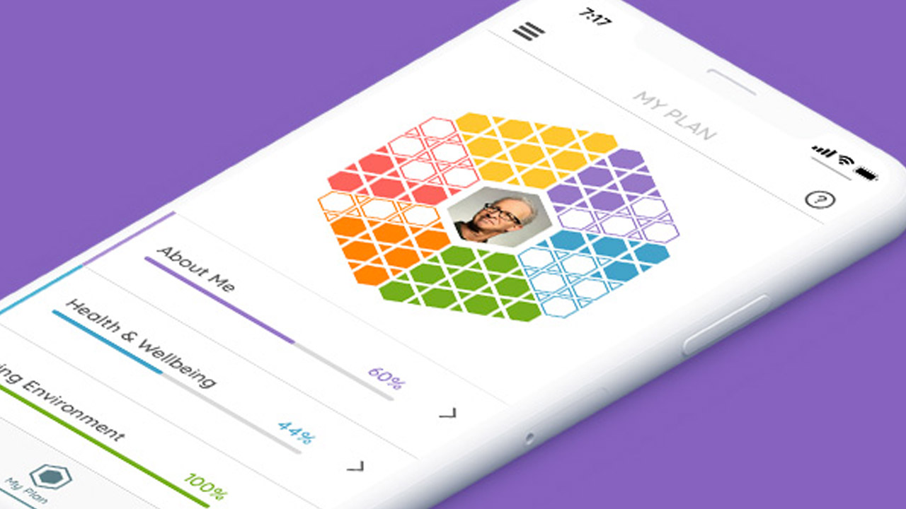 A mobile phone showing the Mosaic app icon. It is a rainbow coloured hexagon, filled with smaller hexagons.