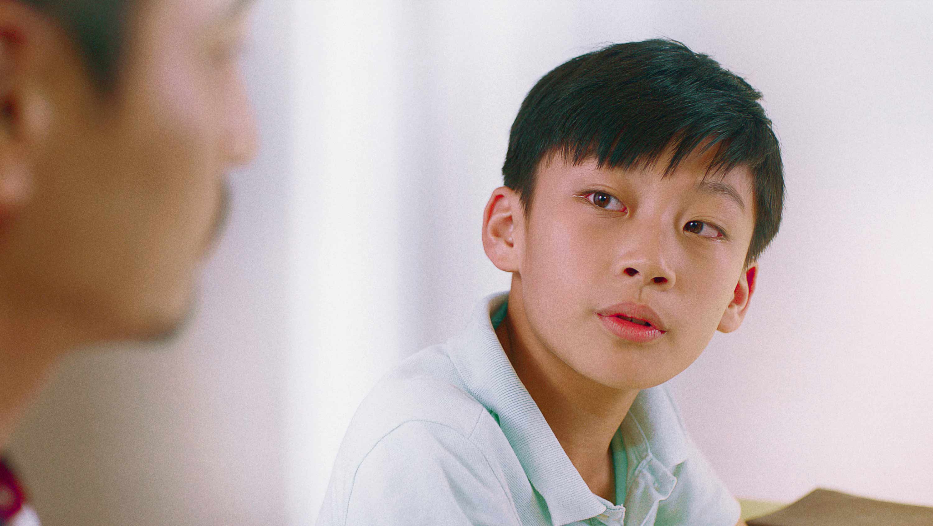 A primary school aged child talking and smiling