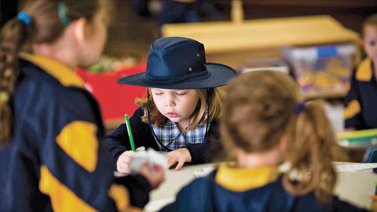 Children sitting at table doing an activity.