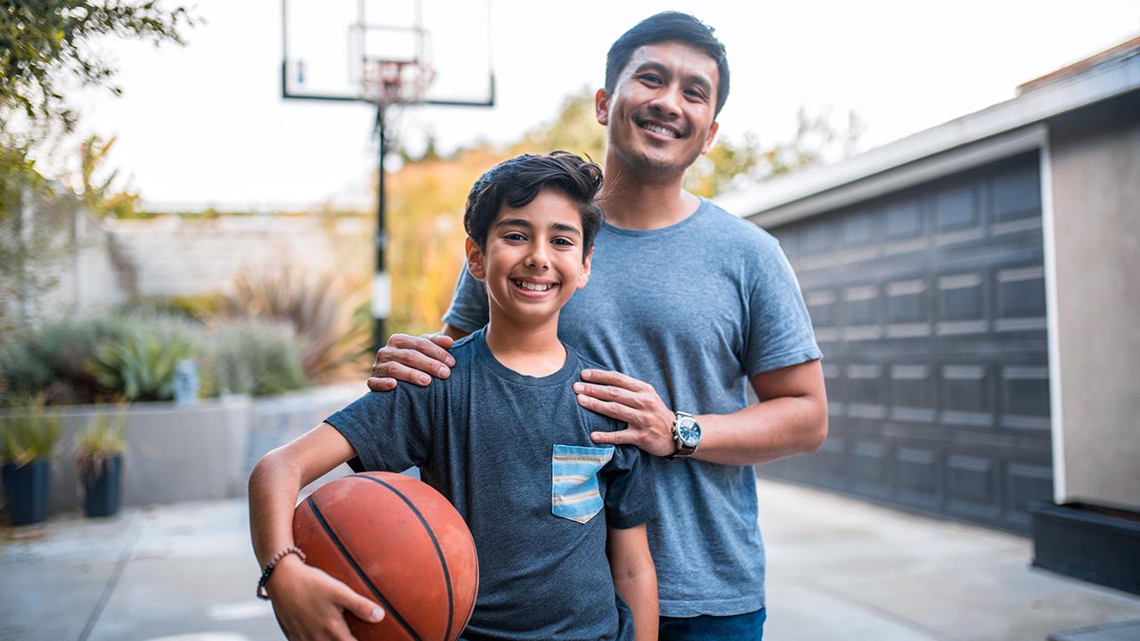 Man and a child playing basketball Man and a child playing basketball
