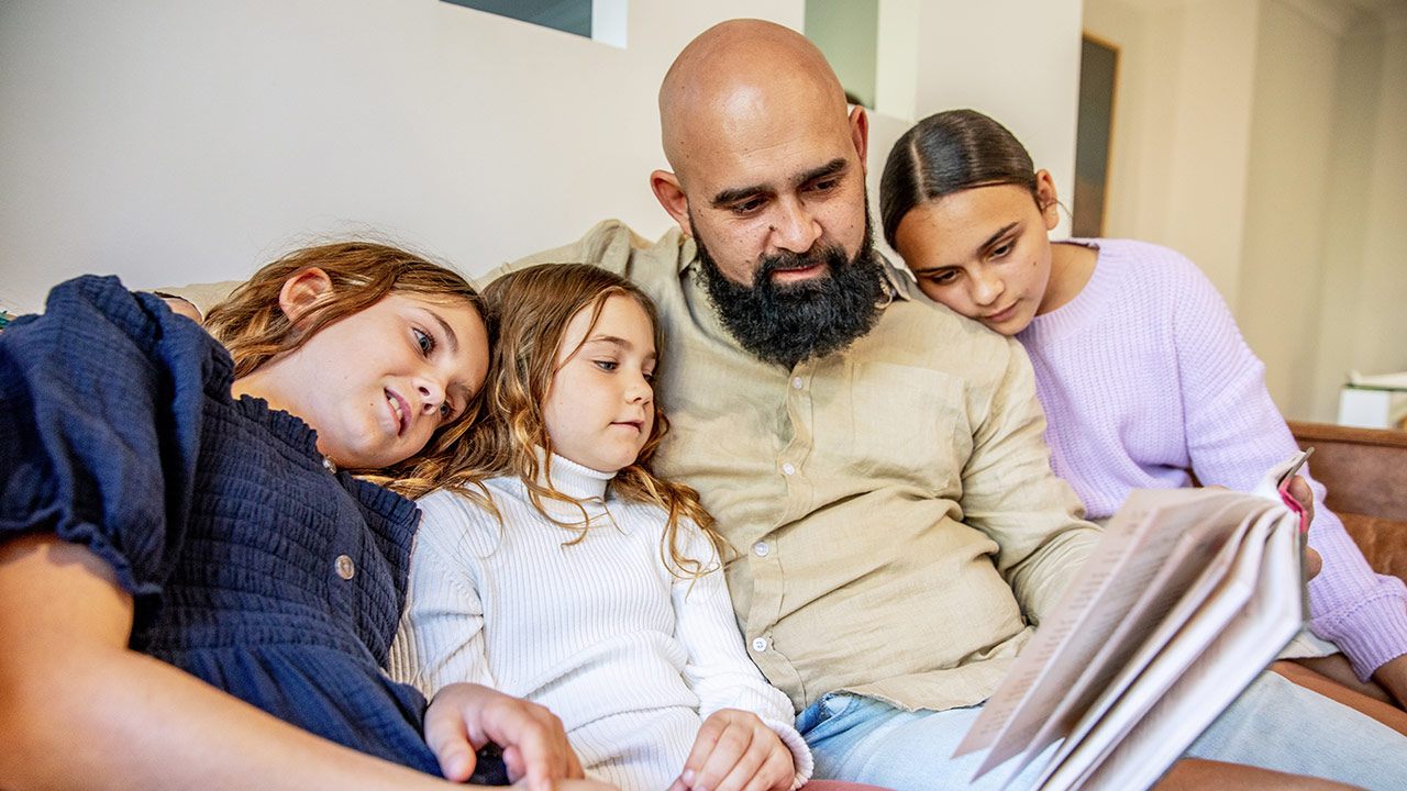 Family sitting on a sofa and reading Family sitting on a sofa and reading