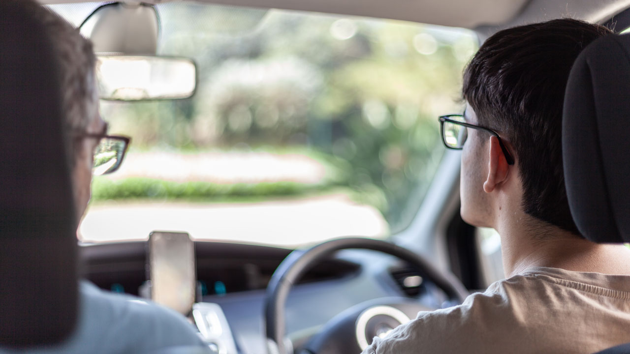 Adult mentoring young person who is learning to drive. Adult mentoring young person who is learning to drive.