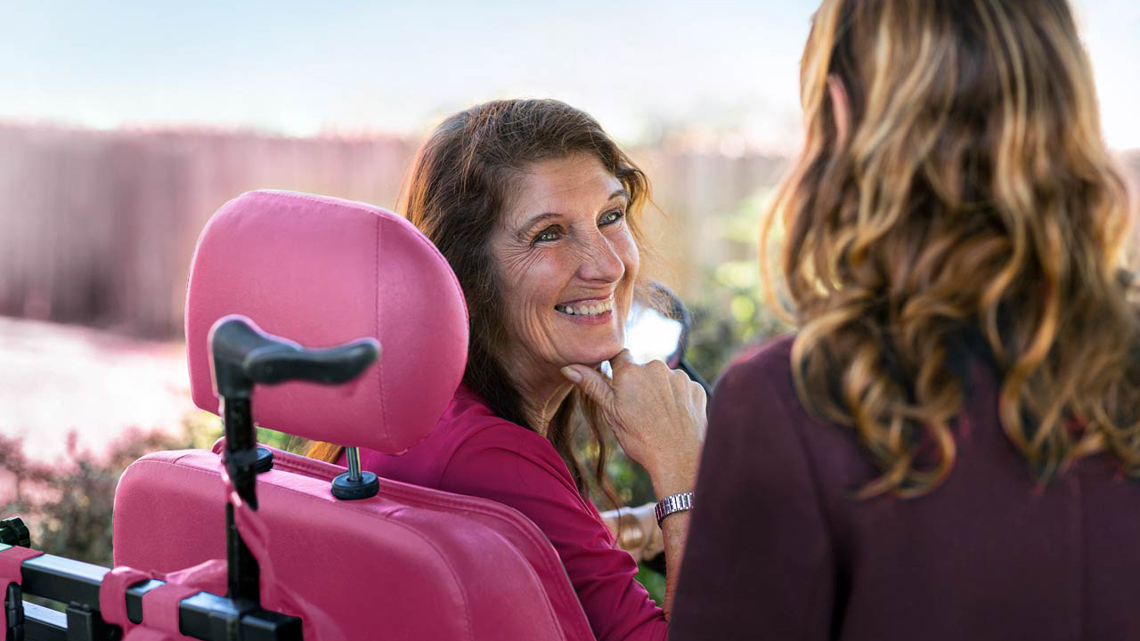 Smiling woman with a disability sitting in a wheelchair Smiling woman with a disability sitting in a wheelchair