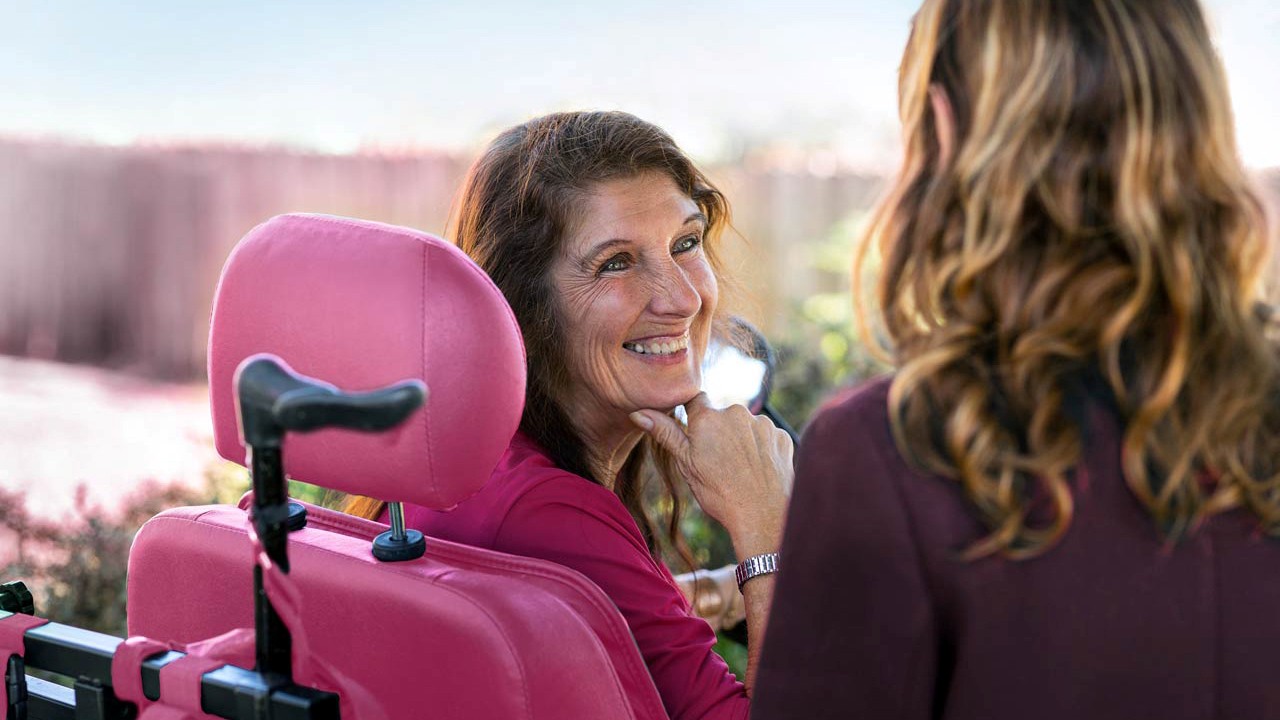 Smiling woman with a disability sitting in a wheelchair