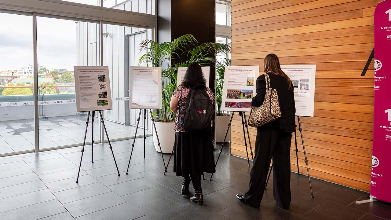 Guests reading freestanding, framed information boards. Guests reading freestanding, framed information boards.