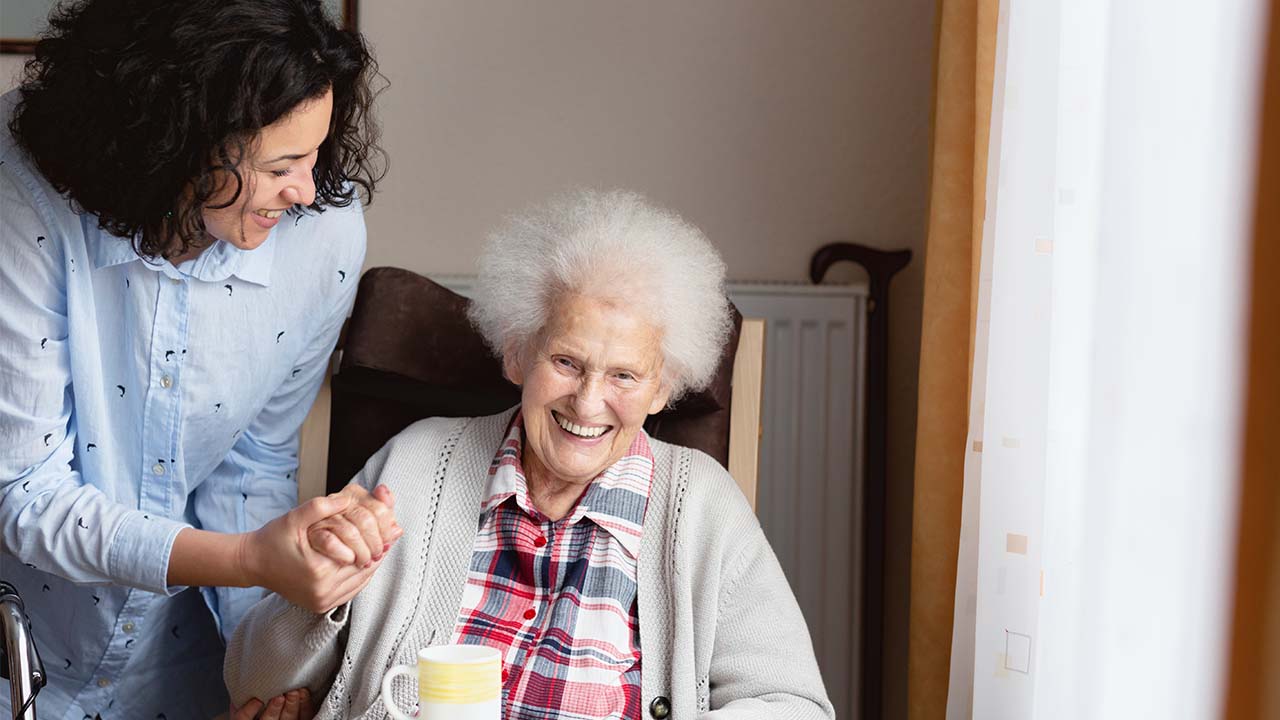 Elderly woman and her carer