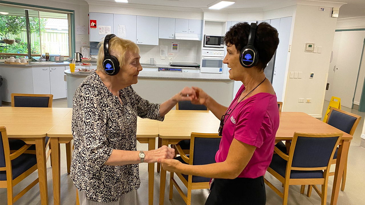 residents dancing with wireless headphones
